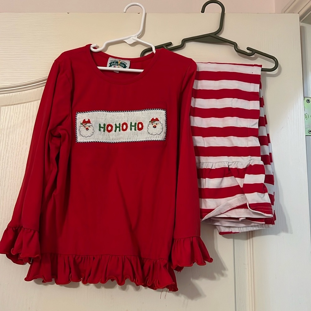 Smocked Christmas shirt and red striped pants.